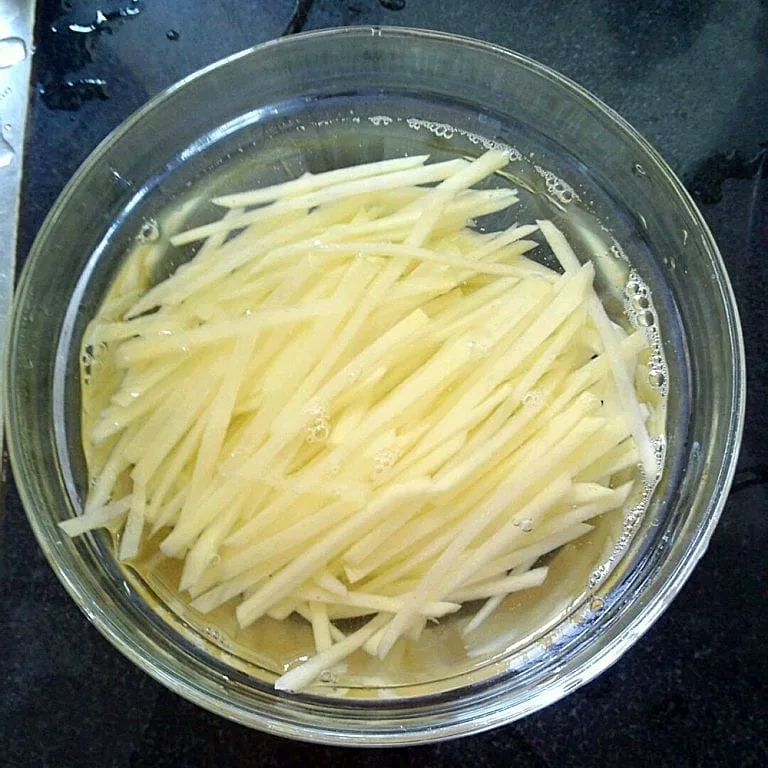 Potato slivers soaking in water