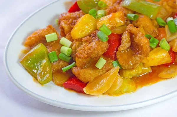 Sweet and sour chicken tossed in the wok